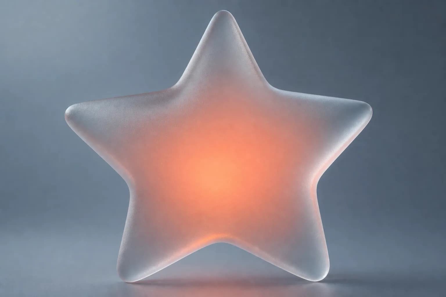 A frosted glass star glowing coral