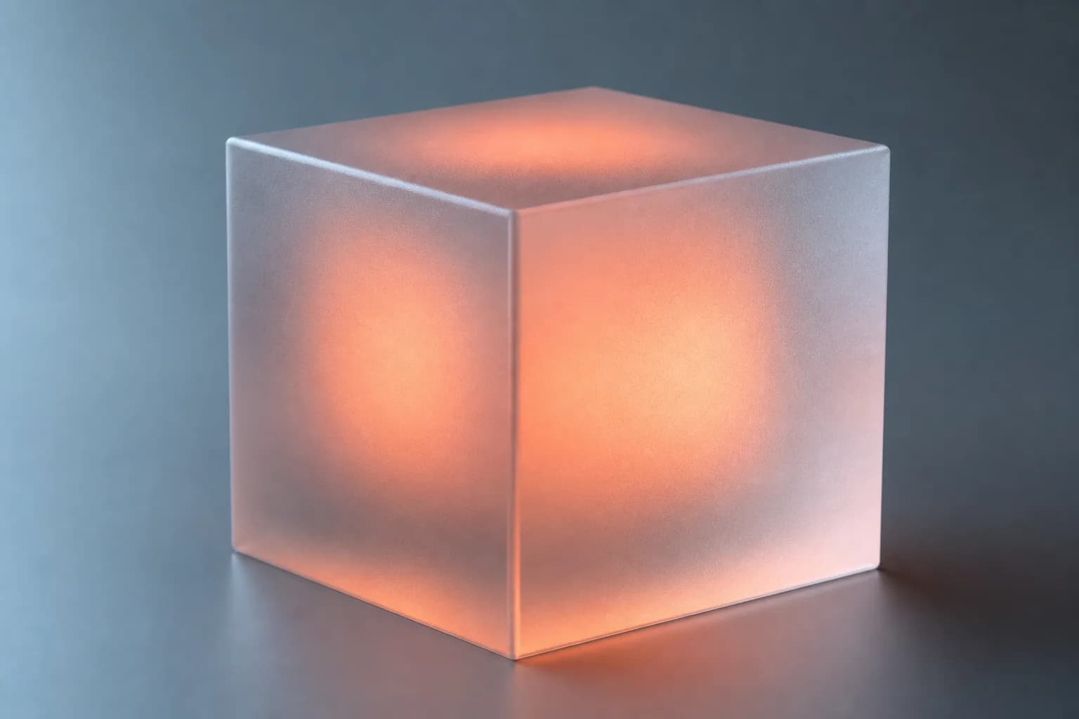 A frosted glass cube glowing coral
